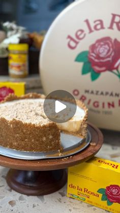 a piece of cake sitting on top of a plate next to a box of marzipan