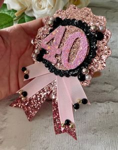 a pink and black pin with the number forty on it