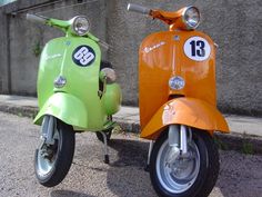 two motor scooters parked next to each other