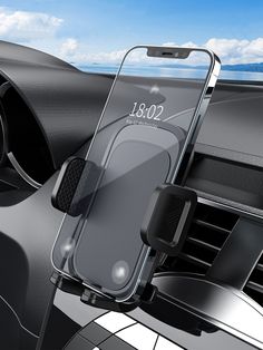 an image of a cell phone in the air vent on a car dashboard with blue sky and clouds behind it