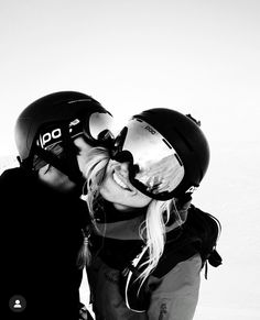 a man and woman kissing each other in the snow