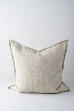 the linen pillow is made from natural linen and has a soft, light beige color