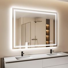 a bathroom with two sinks and a large mirror on the wall above it's lights