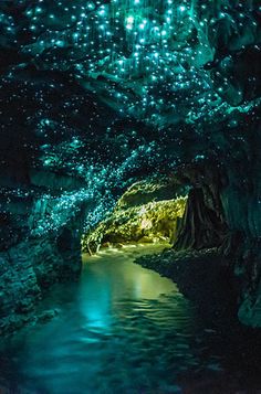 the inside of a cave with water and stars