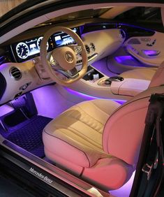 the interior of a car is shown with purple lighting