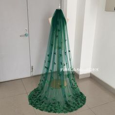 a green wedding veil with flowers on it