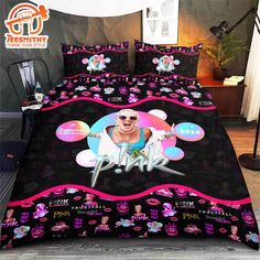 a bed covered in pink and black bedspread with an image of elvis presley on it