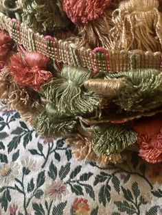 a pile of fabric with flowers and leaves on it