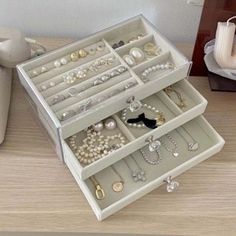 an assortment of jewelry sits on a table