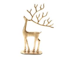 a gold deer figurine with branches on it's antlers, against a white background