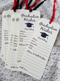 four graduation wishes tags with red and black ribbons