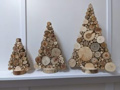 three pieces of wood are stacked on top of each other in the shape of christmas trees