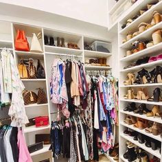 a closet filled with lots of different types of shoes and handbags on shelving units