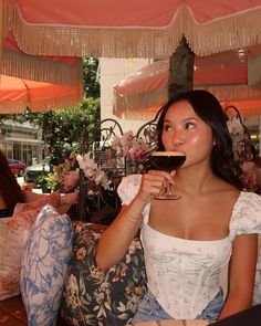 a woman sitting on a couch holding a glass of wine