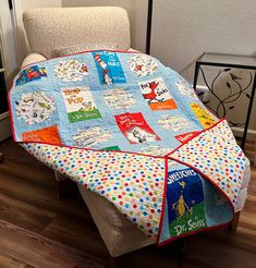 a cat in the hat themed baby blanket on a chair with a dr seuss book