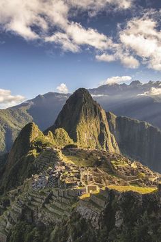 the ruins of machaca picach are surrounded by mountains and clouds in the background