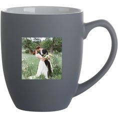 a gray coffee mug with a photo of a bride and groom kissing in the grass