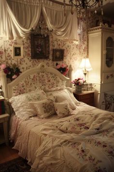 a white bed sitting in a bedroom next to a window with curtains on top of it