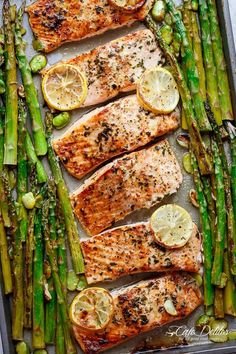 salmon and asparagus on a sheet pan with lemons, green beans and seasonings