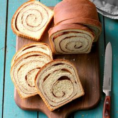 sliced loaf of bread sitting on top of a wooden cutting board