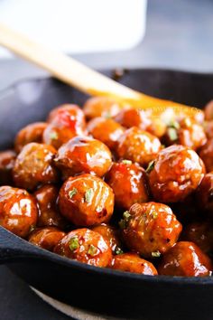 a skillet filled with meatballs covered in sauce