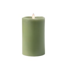 a green candle is lit on a white background