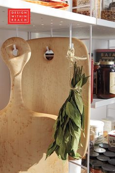 a wooden cutting board sitting on top of a shelf