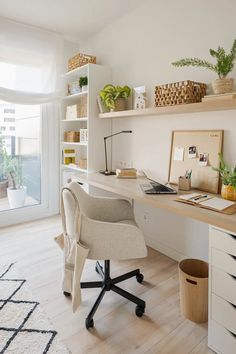 a home office with white walls and wooden floors