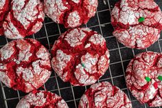 red velvet crinkle cookies on a cooling rack with green sprinkles