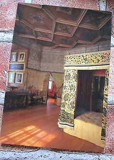 the inside of an old house with paintings on the walls and wood flooring in it