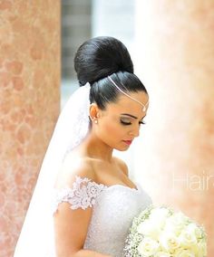 a woman in a wedding dress holding a bouquet