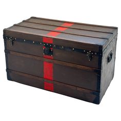 an old trunk with red and black stripes on the bottom is sitting in front of a white background