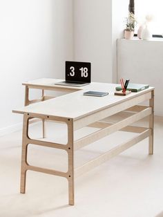 a table with a clock on it in the middle of a room