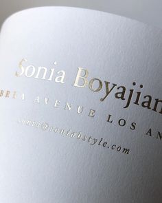 a close up view of the label on a wine bottle that is white and gold