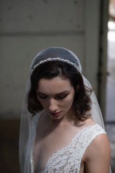 a woman in a wedding dress wearing a veil