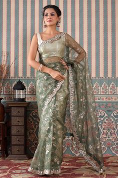 Look royal in this beautiful green embroidered organza saree on festive occasions! It comes with a blouse piece. Disclaimer: The actual product may vary slightly from the image. These are custom orders, hence expect slight variation in color, placement of the motif or buta. ESTIMATED DELIVERYBecause this is a custom order, it would take about 4 weeks from the date of purchase. RETURN POLICYThis product is a custom order and cannot be returned or exchanged. Wedding Sarees, Handloom Saree