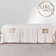 a table with a white cloth on it and the words link shop written above it