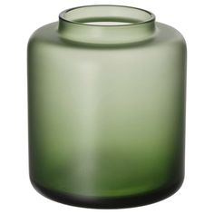 a green glass vase sitting on top of a white table