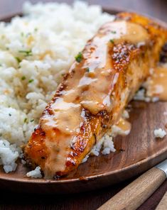 a plate topped with rice and meat covered in gravy