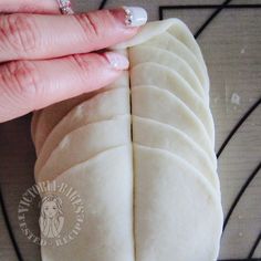 a close up of a person holding a piece of bread