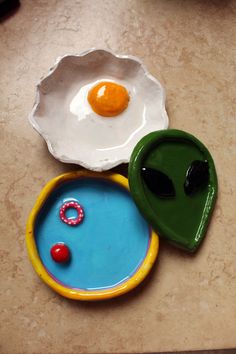 two plates with an egg on top and another plate with an object in the middle