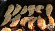 several pieces of chicken cooking on a grill