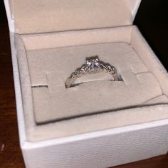 an engagement ring in a box on a table