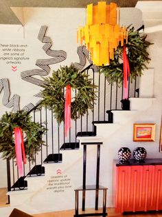 a staircase decorated with christmas decorations and potted plants