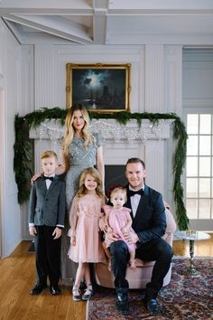 a family posing for a photo in front of a fireplace with the caption instagram