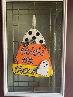 a halloween door hanger with a trick or treat on it