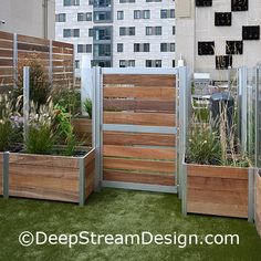 several wooden planters on the roof of a building with grass and plants growing in them