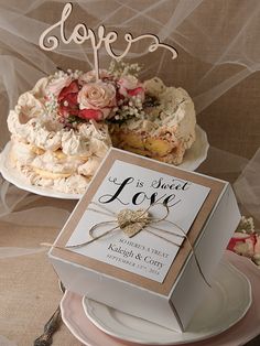 two wedding cakes on plates with the cake topper saying, love is sweet love