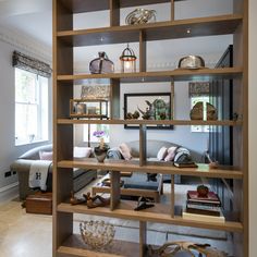 a living room filled with lots of wooden shelves