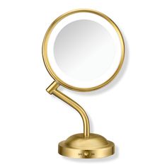 a gold mirror on a stand with a white background